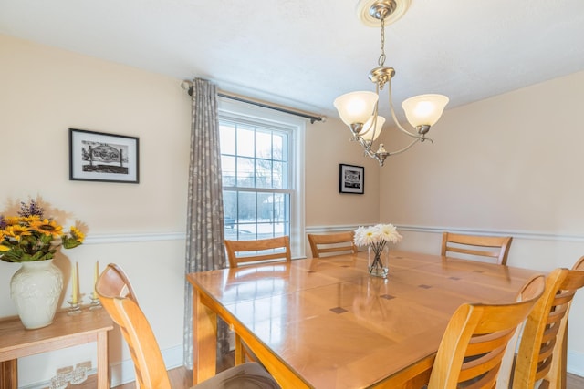 dining space featuring a chandelier