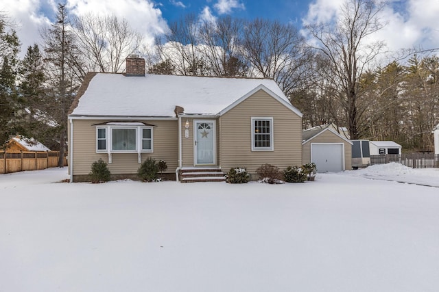 view of front of home with a garage and an outdoor structure