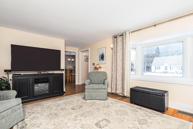 living room featuring a notable chandelier and wood-type flooring