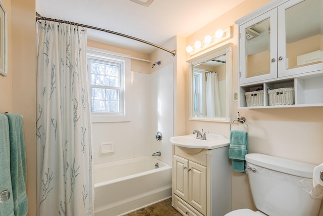 full bathroom with vanity, shower / bath combo, and toilet