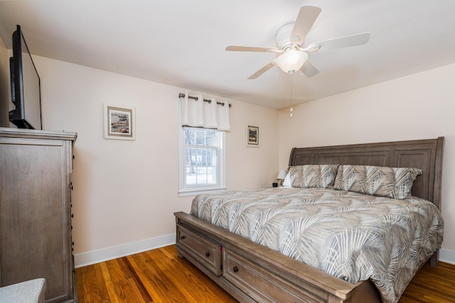 bedroom with dark hardwood / wood-style floors and ceiling fan