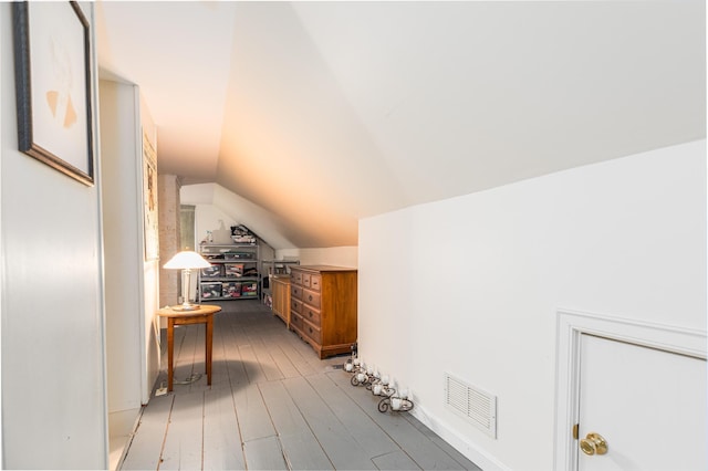 bonus room with lofted ceiling and light hardwood / wood-style flooring