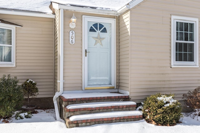 view of snow covered property entrance