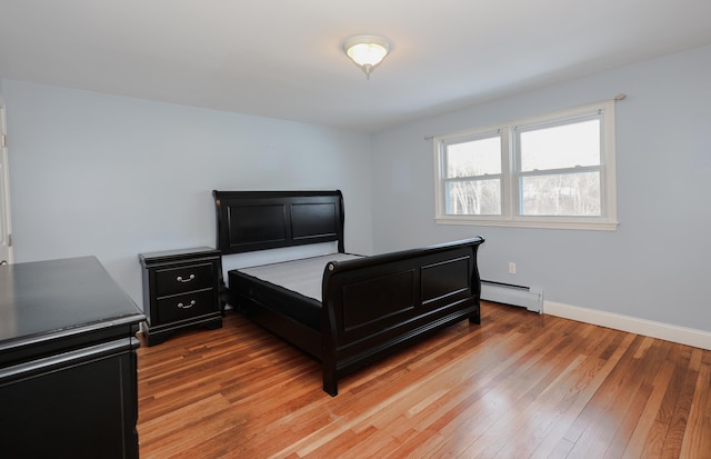 bedroom featuring hardwood / wood-style flooring and a baseboard radiator