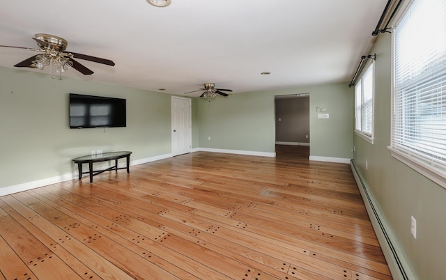 unfurnished living room featuring wood-type flooring, a baseboard heating unit, and ceiling fan