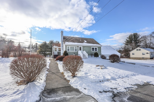 view of snow covered rear of property