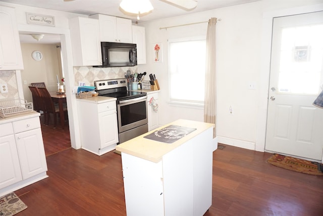 kitchen with tasteful backsplash, white cabinetry, dark hardwood / wood-style flooring, and stainless steel range with electric cooktop