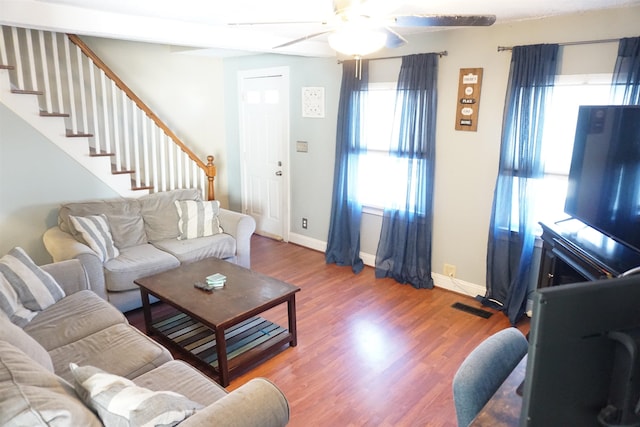 living room with wood-type flooring and ceiling fan