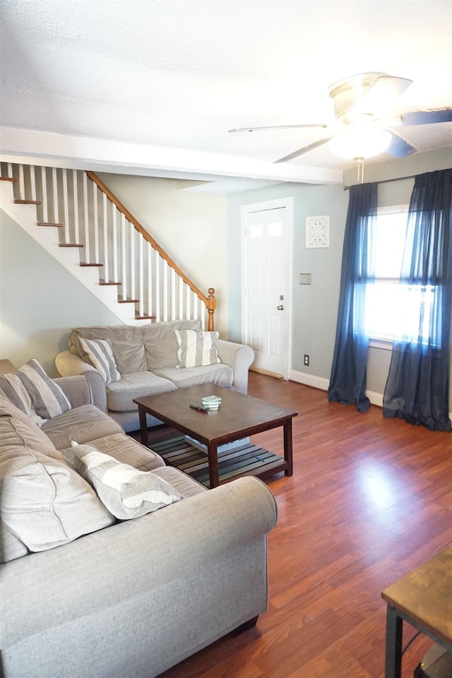 living room with ceiling fan and dark hardwood / wood-style flooring