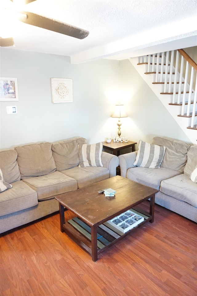 living room with hardwood / wood-style flooring and a textured ceiling