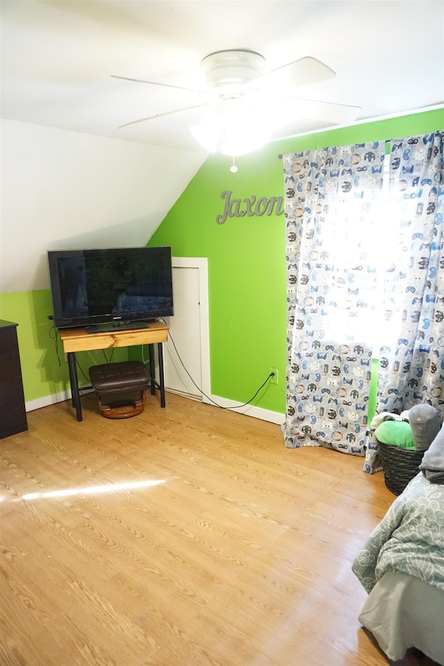 interior space with hardwood / wood-style floors, vaulted ceiling, and ceiling fan