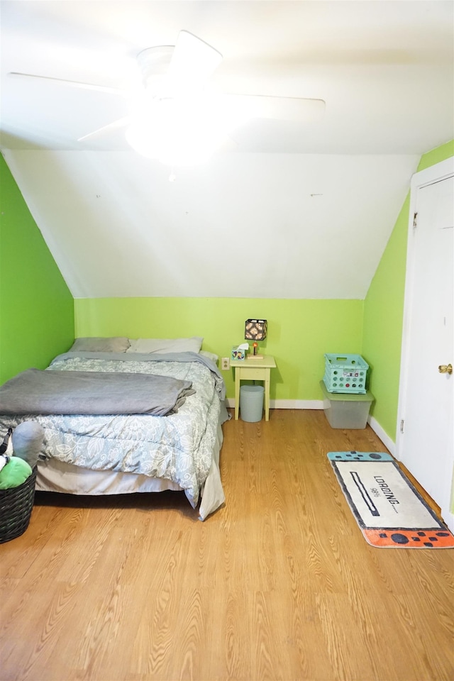 bedroom featuring lofted ceiling, ceiling fan, and light wood-type flooring