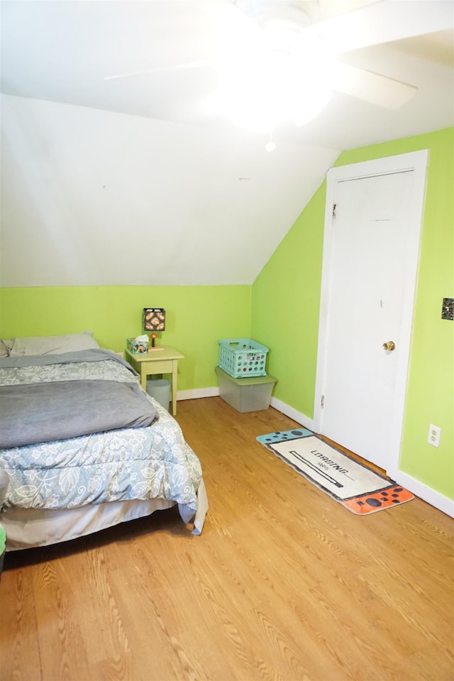 bedroom featuring vaulted ceiling, ceiling fan, and hardwood / wood-style floors