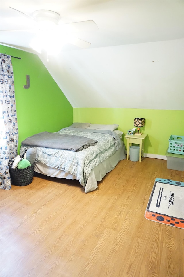 bedroom featuring ceiling fan, wood-type flooring, and vaulted ceiling