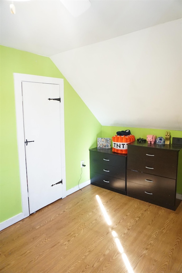 bonus room with lofted ceiling and light hardwood / wood-style flooring