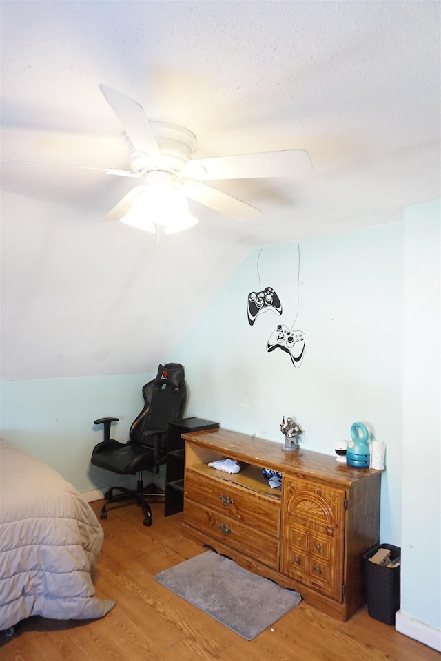 office area featuring vaulted ceiling, ceiling fan, and light wood-type flooring