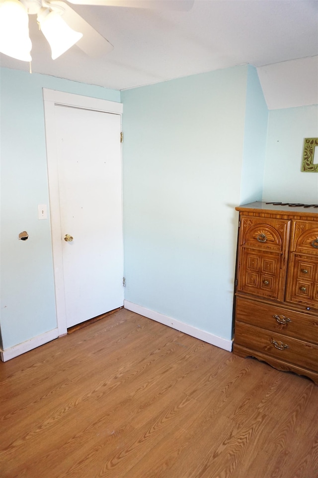 unfurnished bedroom with a closet, ceiling fan, and light hardwood / wood-style flooring