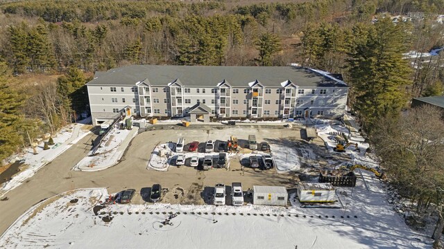 birds eye view of property featuring a view of trees