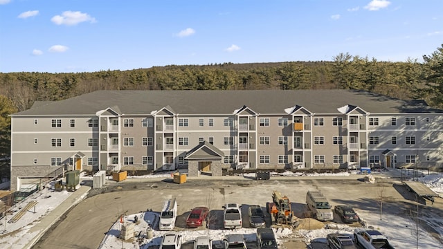 view of building exterior with a wooded view