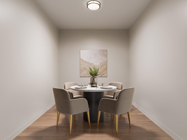 dining room with baseboards and wood finished floors