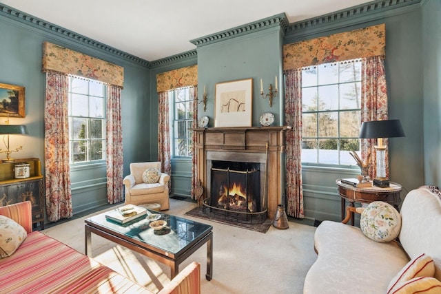 living area with crown molding and carpet flooring