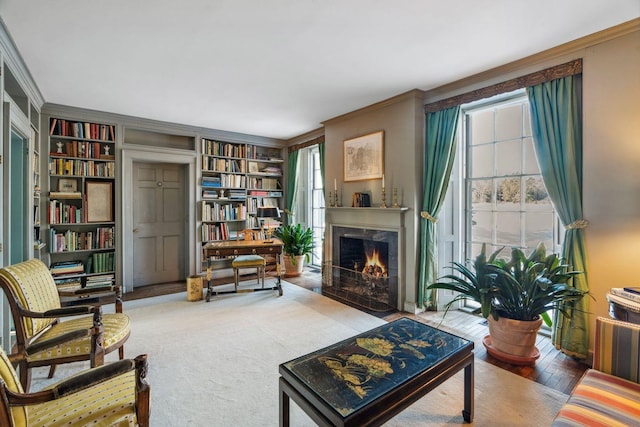 living room with crown molding, carpet, and built in features