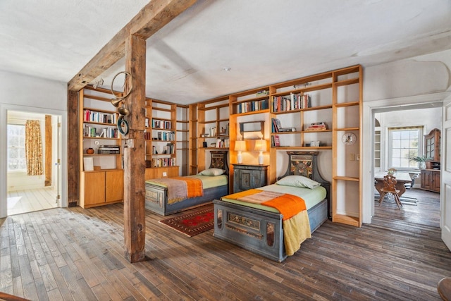 bedroom featuring ensuite bathroom and dark hardwood / wood-style floors