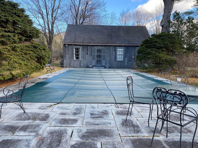 view of pool featuring an outdoor structure and a patio area