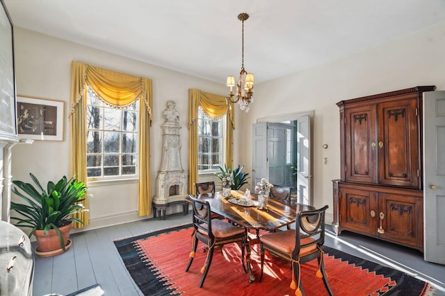 dining room featuring wood-type flooring and an inviting chandelier