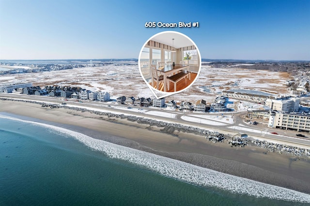 birds eye view of property with a water view and a view of the beach