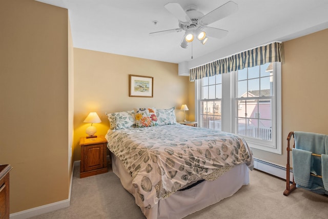 bedroom featuring ceiling fan, light colored carpet, and a baseboard heating unit