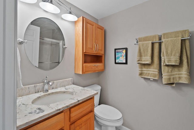 bathroom with vanity, toilet, and an enclosed shower