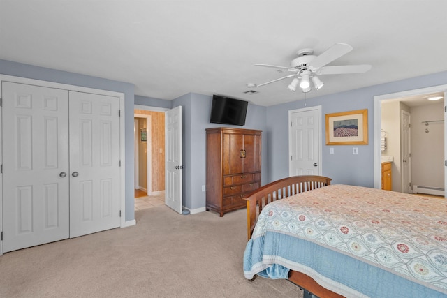 carpeted bedroom featuring ensuite bathroom, a baseboard heating unit, and ceiling fan