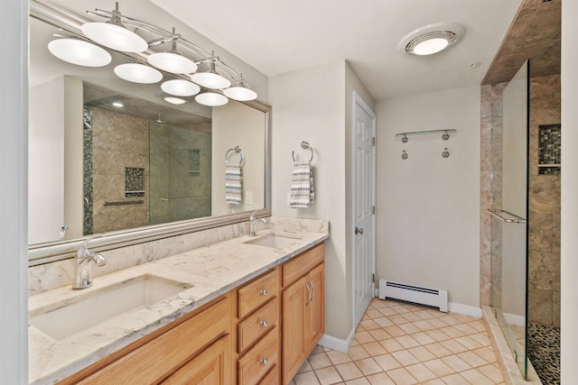 bathroom with vanity, tile patterned floors, tiled shower, and baseboard heating