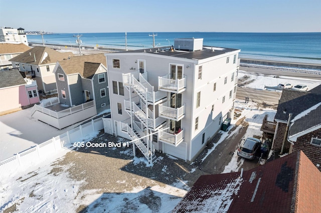 birds eye view of property featuring a beach view and a water view