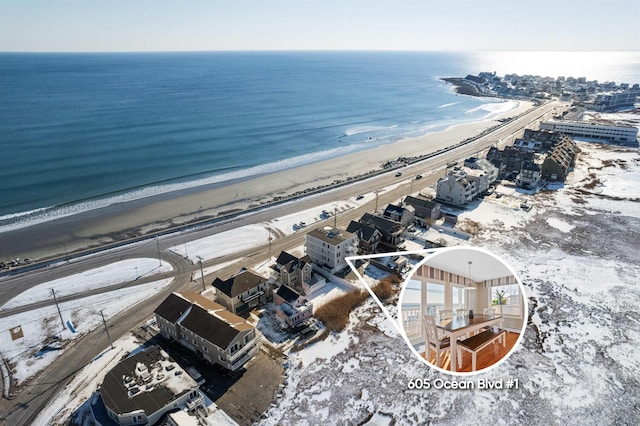 drone / aerial view featuring a water view and a beach view