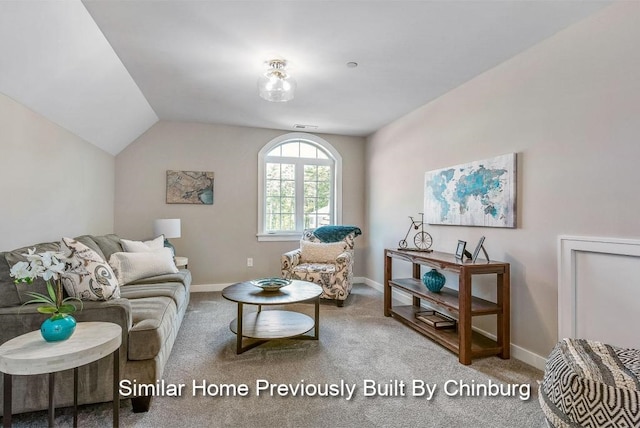 carpeted living room featuring lofted ceiling