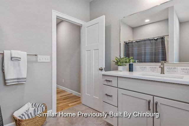 bathroom with vanity, curtained shower, and wood-type flooring