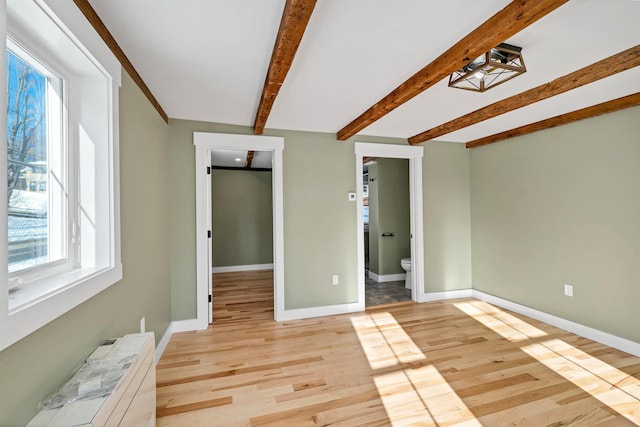 95 Plymouth St, Meredith, NH 03253 - unfurnished room with baseboards, beamed ceiling, and light wood finished floors
