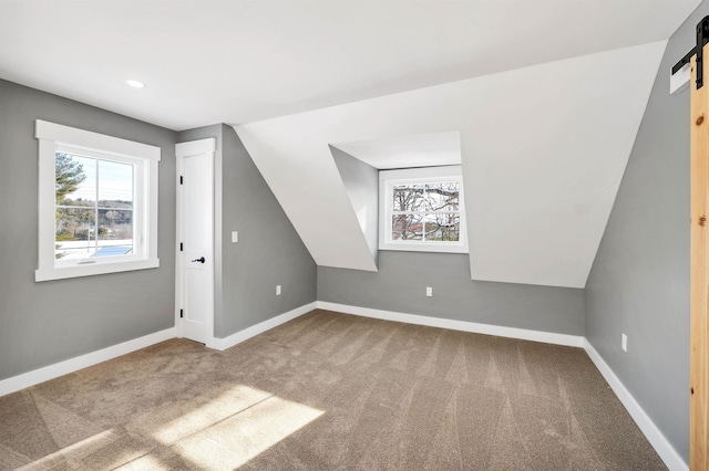95 Plymouth St, Meredith, NH 03253 - additional living space featuring a barn door, carpet floors, baseboards, and recessed lighting
