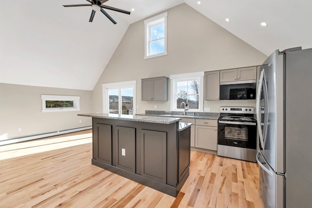 95 Plymouth St, Meredith, NH 03253 - kitchen featuring stainless steel appliances, gray cabinetry, baseboard heating, high vaulted ceiling, and light wood-type flooring