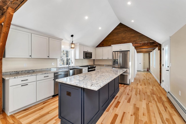 95 Plymouth St, Meredith, NH 03253 - kitchen featuring stainless steel appliances, baseboard heating, a sink, a kitchen island, and lofted ceiling