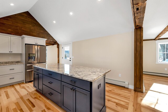 95 Plymouth St, Meredith, NH 03253 - kitchen featuring stainless steel fridge with ice dispenser, a baseboard heating unit, light wood-style flooring, white cabinetry, and light stone counters
