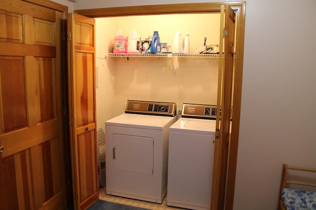 clothes washing area with separate washer and dryer