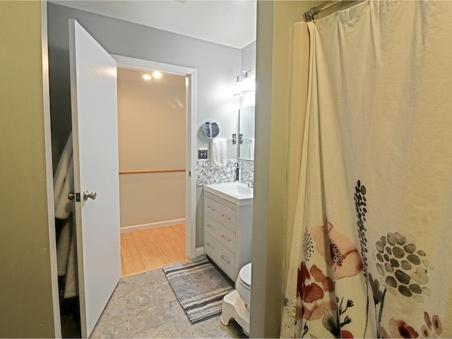 bathroom featuring vanity, toilet, backsplash, and a shower with shower curtain