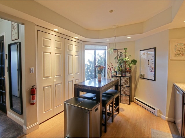 dining room featuring a baseboard radiator and light hardwood / wood-style floors