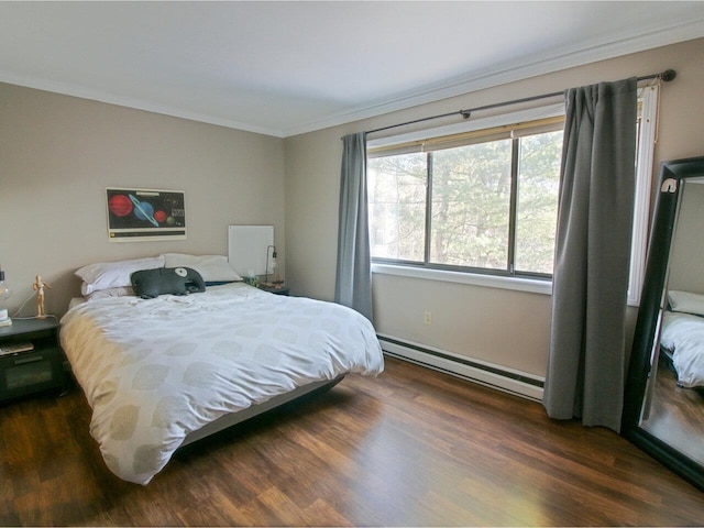 bedroom featuring ornamental molding, dark hardwood / wood-style floors, and a baseboard heating unit