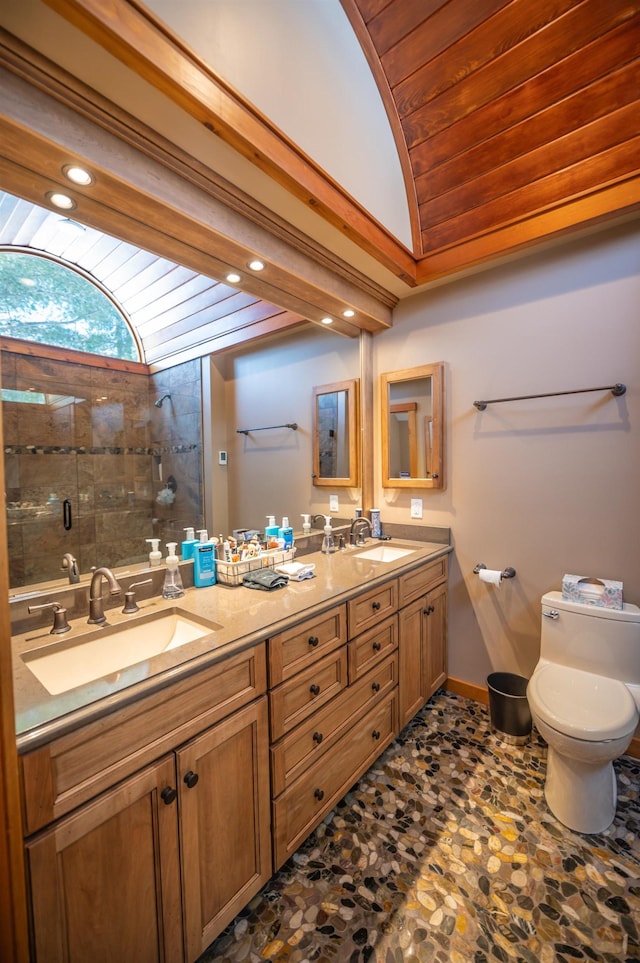 bathroom with walk in shower, vanity, toilet, and vaulted ceiling