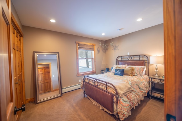 bedroom with carpet and a baseboard heating unit