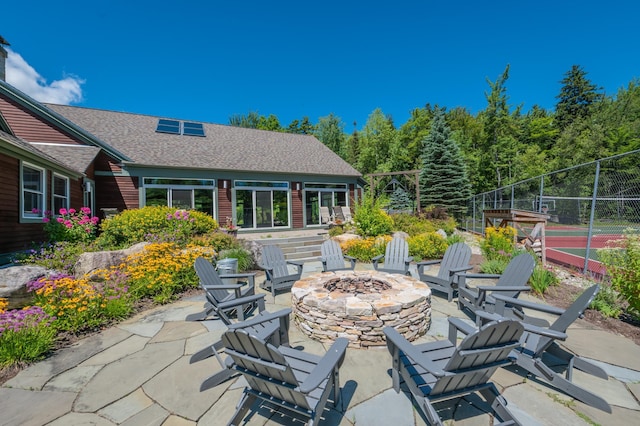 view of patio featuring a fire pit and tennis court